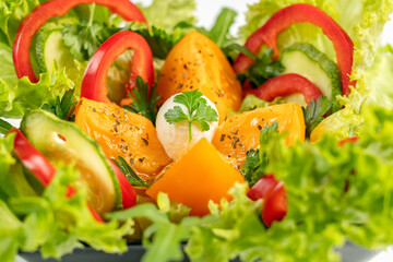 Vegetable salad is a low-calorie cold vegetarian snack. The dish contains the following ingredients: mozzarella, tomatoes, bell pepper, cucumber and lettuce.