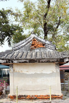 White Cement Wall And Triangle Shape Roof Of Back Side Of Ancient Small Shrine, Roof Area Broken Open Orange Brick, Thailand.