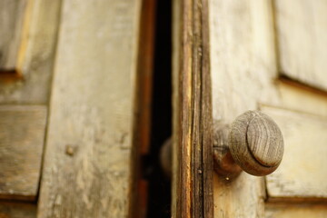 old brown shabby wooden door with a round knob