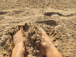 foot plunged in sand