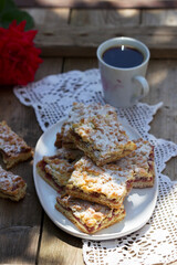 Streusel pie stuffed with rose jam, served with coffee. Rustic style.
