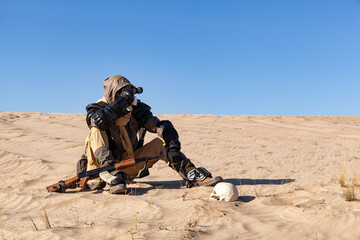 Post apocalyptic warrior sitting in the desert.