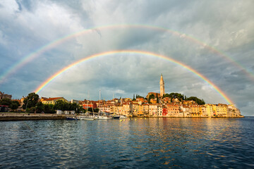 Fototapeta na wymiar Wonderful morning view of old Rovinj town with multicolored buildings and yachts moored along embankment, Croatia.