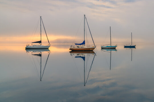 Misty Morning with Boats and Reflections on the Bay