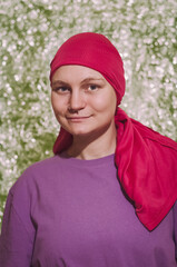 caucasian woman with breast cancer wearing pink chemo hat. Optimistic woman.