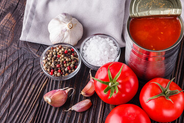 juicy canned tomatoes on wooden rustic background