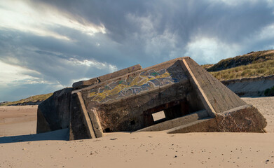 ruins of german bunker in the beach of Normandy, France