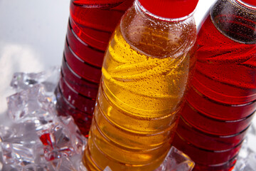 Three bottles with ice tea, with water drops, close up