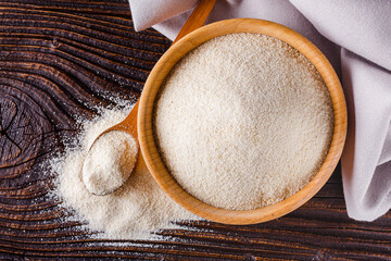 natural organic semolina on dark wooden rustic background