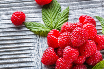 juicy fresh natural raspberries on a gray wooden rustic background