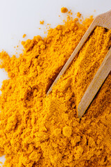 natural turmeric powder on white acrylic background
