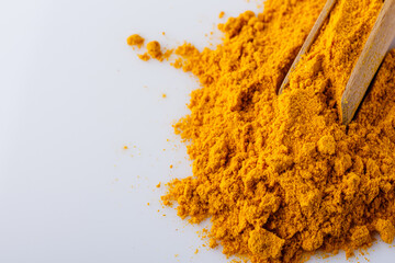 natural turmeric powder on white acrylic background