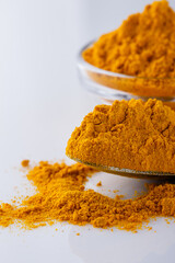 natural turmeric powder on white acrylic background