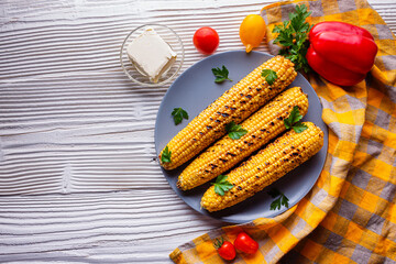 grilled corn cob on white wooden rustic background