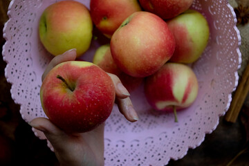 Autumn wooden background with dry leaves and ripe apples. Fall.