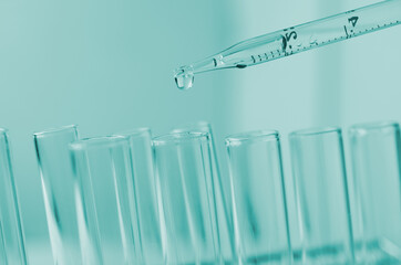 Pipette dropping a sample into a test tube and science experiments ,Laboratory glassware containing chemical liquid