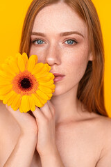 Pretty lady touching face with flowers