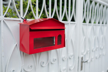 red mailbox on white door background, letterbox 
