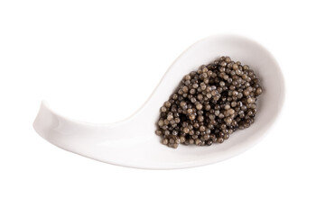 Black caviar in white spoon isolated on white background. Ceramic spoon with sturgeon caviar. Top view.