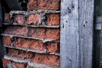 old ruined brickwork and a surface of vintage wooden boards