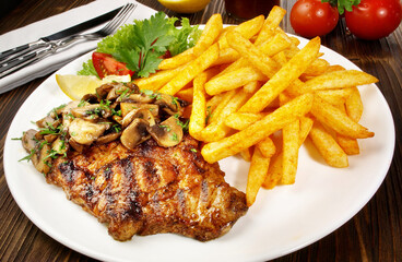 Grilled Pork Neck Steak with French Fries, Onions and Mushrooms