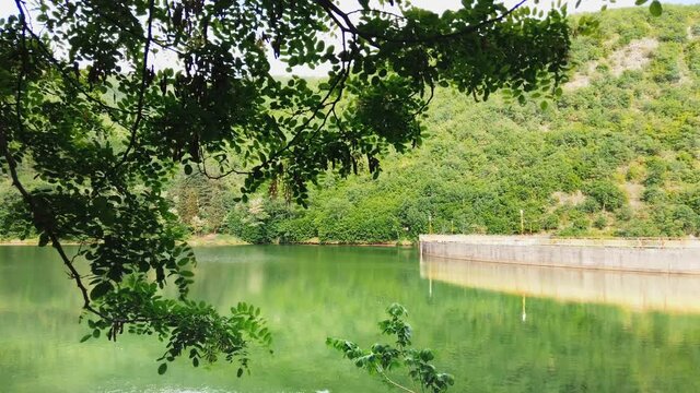 mountain spring lake dam with nice water reflectioni