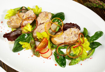 Roasted Veal Appetizer on green Asparagus and Vegetables