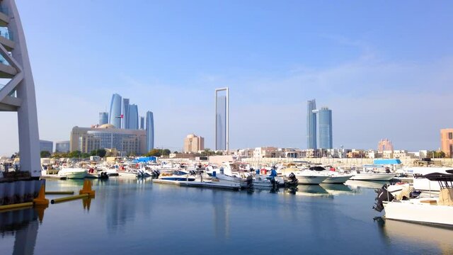 Abu Dhabi skyline and Al Marasy Marina with luxury yachts with view of downtown area of UAE capital view at a sunny day