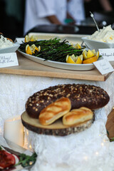 food and vegetables on unique buffet with white table cloth