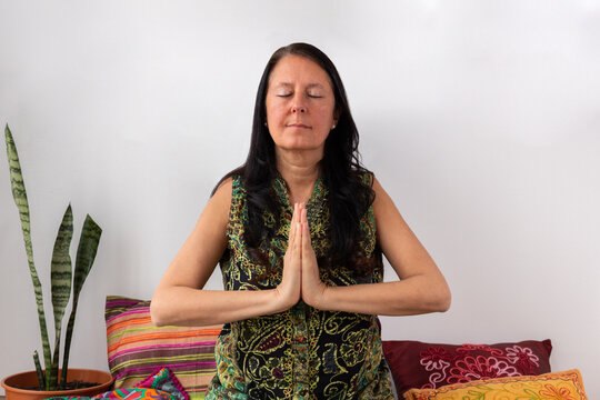 Middle age woman in meditation position with soft background. Concept of relax and zen.