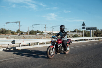 Man rides a motorcycle in the city.Motorcyclist riding a bike during the day on the road