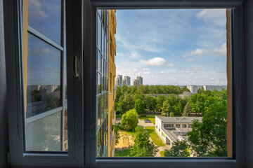 Modern city architecture. View from window. Sunny summer day.