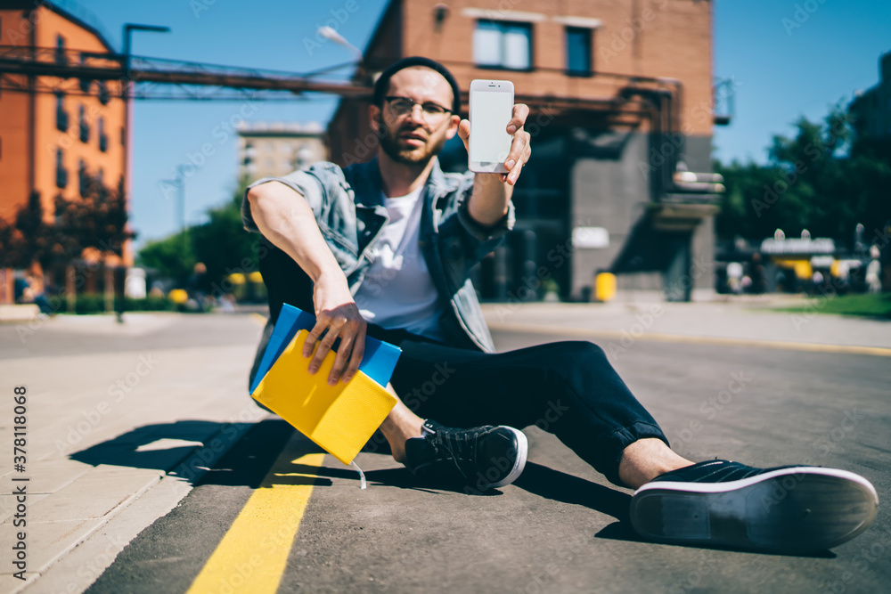 Poster millennial generation y showing cellphone device with mockup screen for internet website connected t