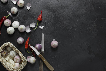 dried chili peppers and garlic on dark background