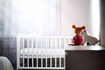 Children's room with an empty cradle and toys on the dresser. Copy space. The concept of abortion...