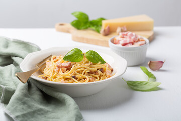 Italian pasta carbonara made with egg, hard cheese, cured pork guanciale or pancetta and black pepper