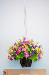 Flowers in hanging rattan pots