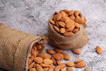 Almonds in bag isolated on grey background