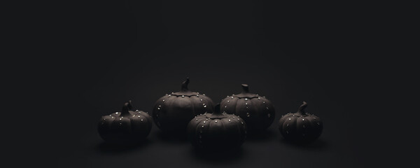 Ceramic pumpkins with rhinestones on a black background. Minimalistic background for autumn holidays with space for text.