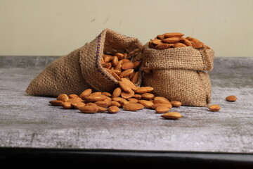 Almonds in bag isolated on grey background