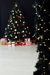 Festive room interior with stylish armchair and beautiful Christmas tree