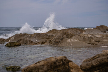 waves crash on stones