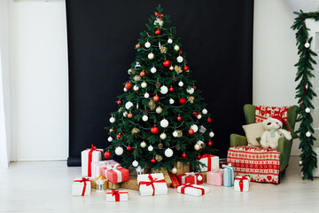 Festive room interior with stylish armchair and beautiful Christmas tree