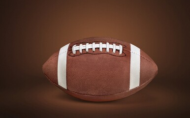 American football ball on brown background