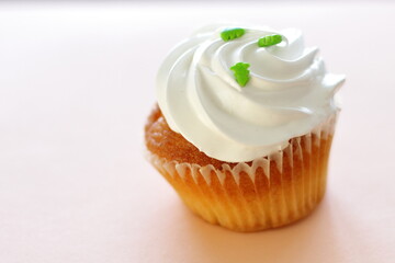 Cupcake decorated by cream meringue and sweet Christmas tree, dessert for party, birthday, new year eve, festive