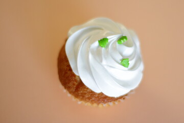 Cupcake decorated by cream meringue and sweet Christmas tree, dessert for party, birthday, new year eve, festive