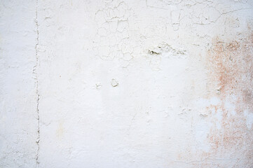 white plaster old wall already has cracks and chipped paint, as texture or background for designs