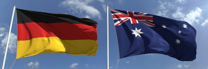 Flying flags of Germany and Australia on sky background, 3d rendering