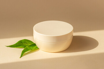 A jar of hand, face, hair or body cream on a stand. Natural cosmetics. Home skin care. Space for text.