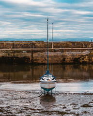 boat in the harbor at low tide